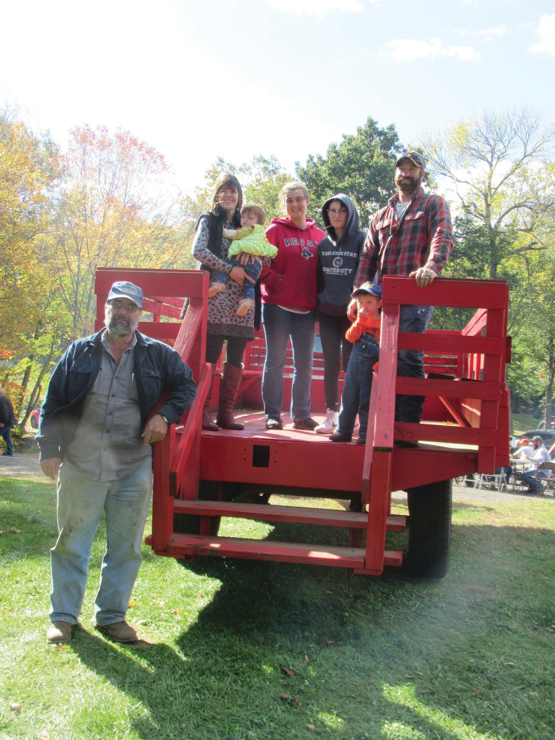 FAMILY FUN: Karl Russo (left) and his family were among the many people of all ages who enjoyed old-fashioned hay rides Sunday at Rossi’s Christmas Tree Farm in Cranston.